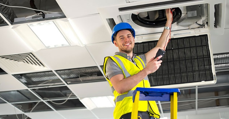 HVAC technician performing an operational assessment on commercial HVAC units